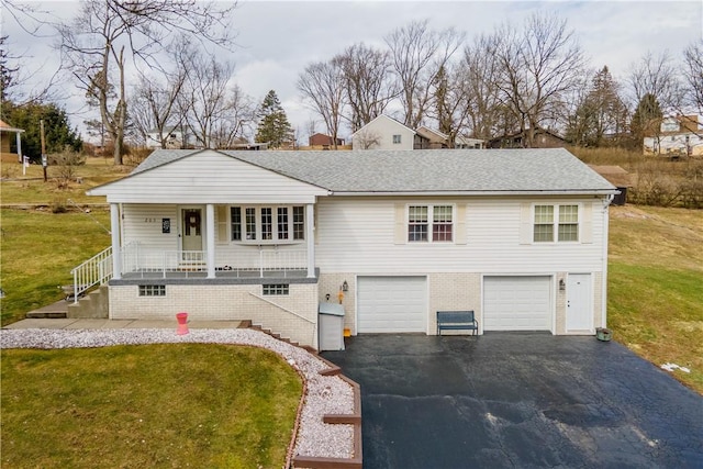 view of front of house with aphalt driveway, a porch, a garage, a shingled roof, and a front yard