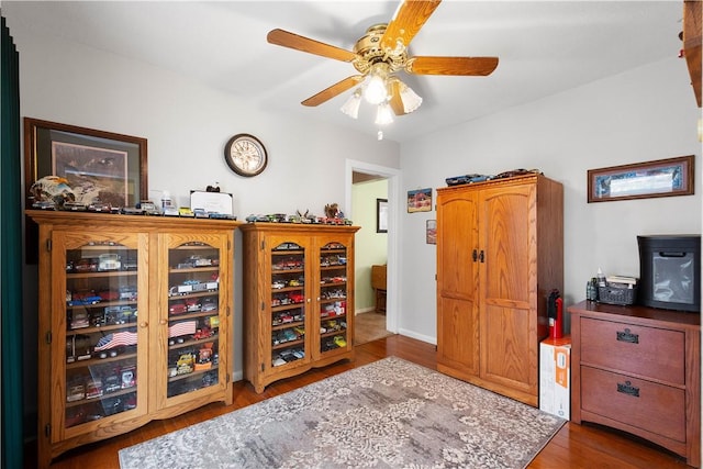 interior space featuring dark wood-style flooring and a ceiling fan