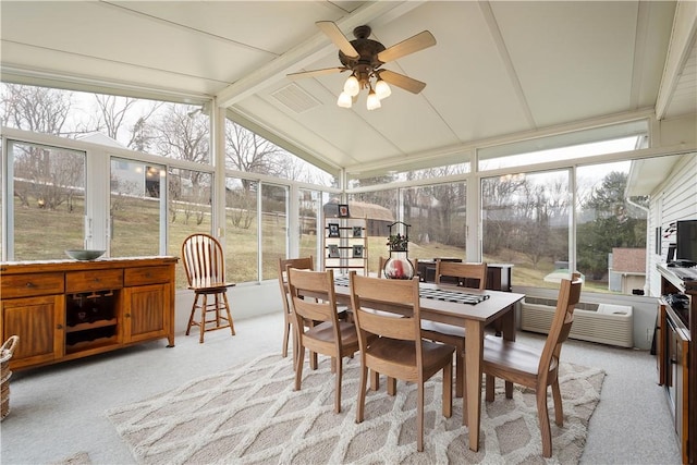 sunroom with lofted ceiling with beams and a ceiling fan