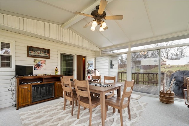 sunroom with lofted ceiling with beams and a ceiling fan