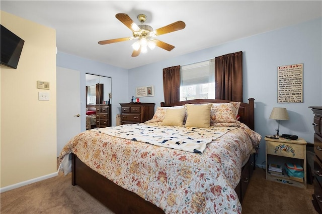 bedroom featuring carpet, a closet, baseboards, and a ceiling fan