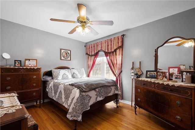 bedroom featuring light wood-type flooring, ceiling fan, and baseboards