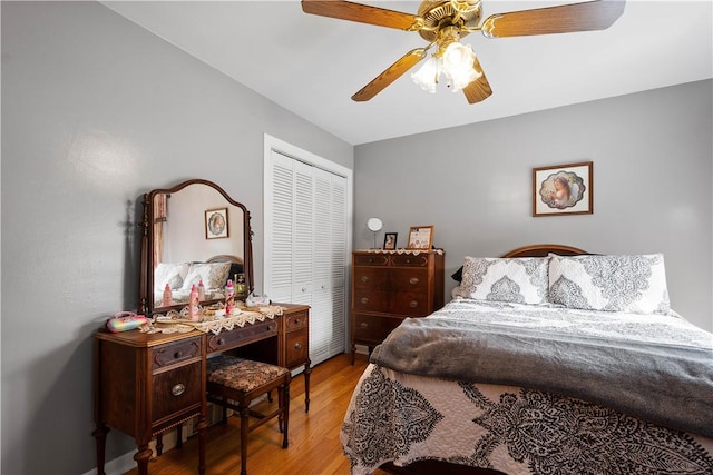 bedroom featuring a ceiling fan, a closet, and wood finished floors