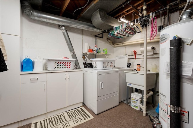 laundry room featuring washer and dryer, water heater, a sink, and cabinet space