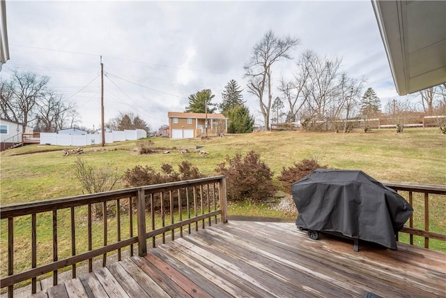 wooden terrace with a yard, an outbuilding, and a grill