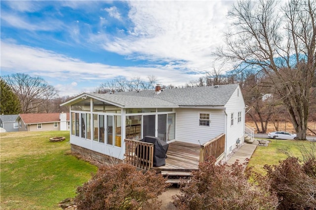 back of house featuring a deck, a yard, a chimney, and a sunroom