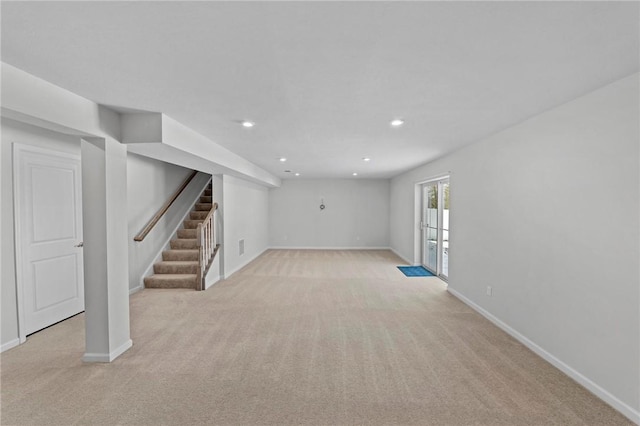 basement featuring stairs, baseboards, light colored carpet, and recessed lighting