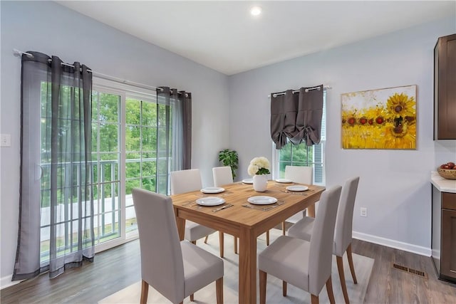 dining room with visible vents, baseboards, and wood finished floors