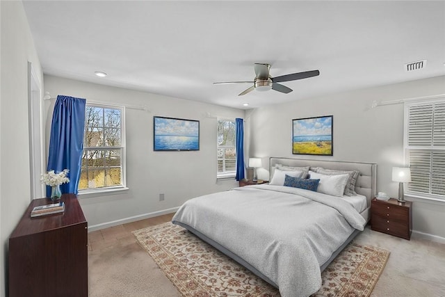 bedroom with a ceiling fan, visible vents, baseboards, and multiple windows