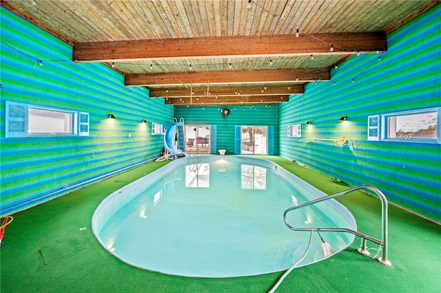 indoor pool featuring a water slide and a hot tub