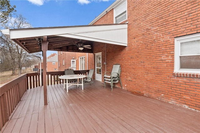 wooden deck featuring outdoor dining space and ceiling fan