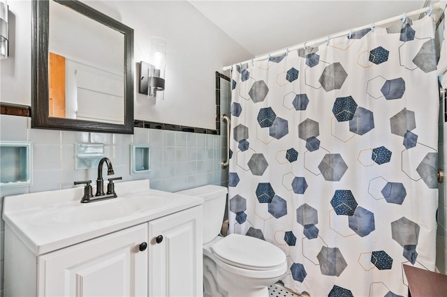 full bath featuring toilet, curtained shower, tile walls, and vanity