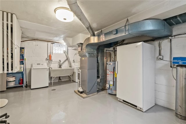 below grade area with water heater, washer and clothes dryer, a sink, and concrete block wall