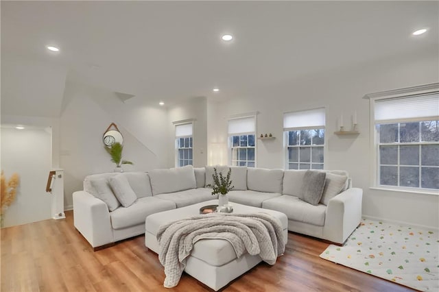 living room with light wood finished floors and recessed lighting