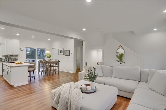 living room with recessed lighting and light wood-style floors