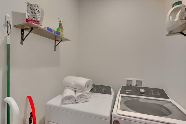 washroom featuring laundry area and separate washer and dryer