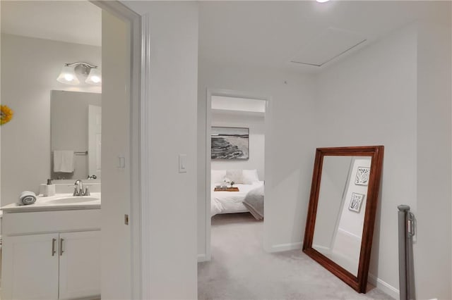 bathroom featuring connected bathroom, vanity, and baseboards