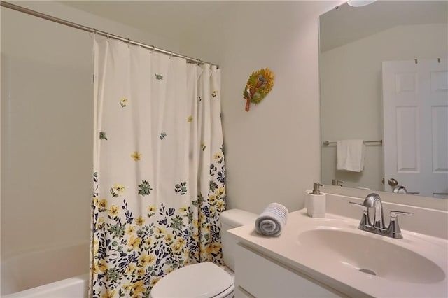 bathroom featuring vanity, shower / bath combination with curtain, and toilet