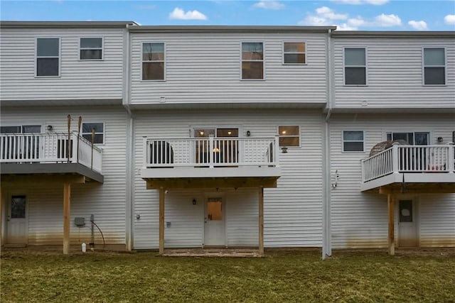 rear view of property with a yard