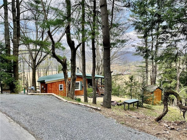 1958 Church Hill Rd, North-Other Area, PA 16351 - chalet / cabin with a storage unit, an outdoor structure, and gravel driveway