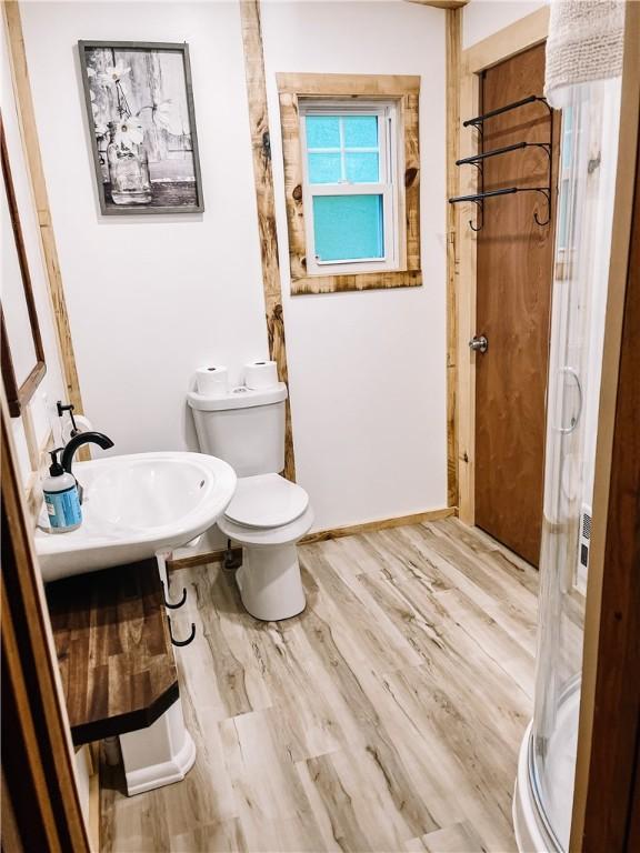 1958 Church Hill Rd, North-Other Area, PA 16351 - full bath featuring toilet, a sink, a shower stall, wood finished floors, and baseboards