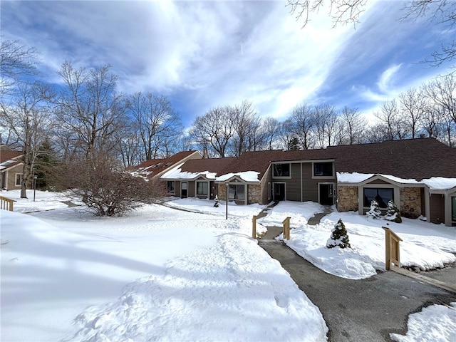 view of front of home featuring a garage and stone siding