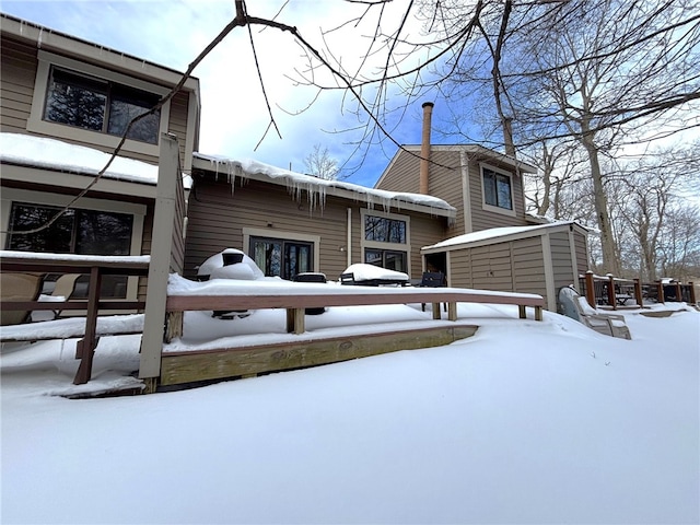 view of snow covered rear of property