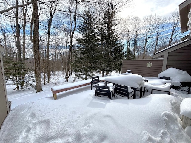 yard layered in snow featuring a garage