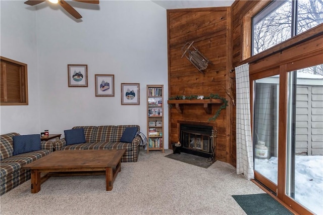 living area with light carpet, high vaulted ceiling, and a fireplace