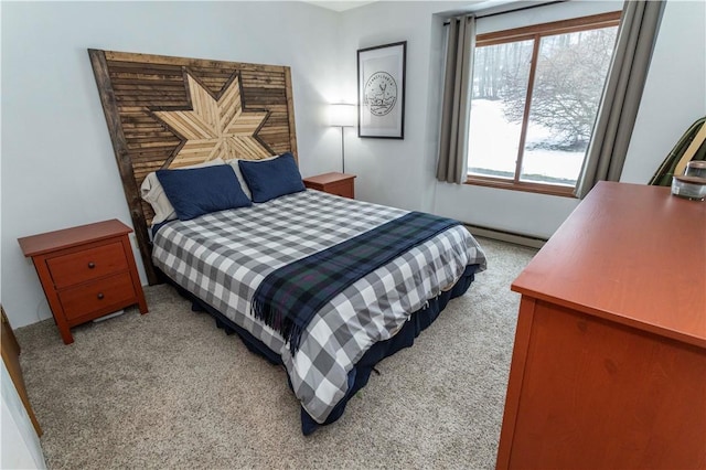 bedroom with light carpet and baseboard heating