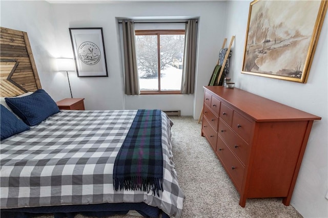 bedroom featuring a baseboard heating unit and light colored carpet