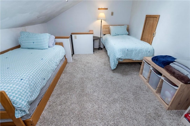 bedroom with lofted ceiling and light colored carpet