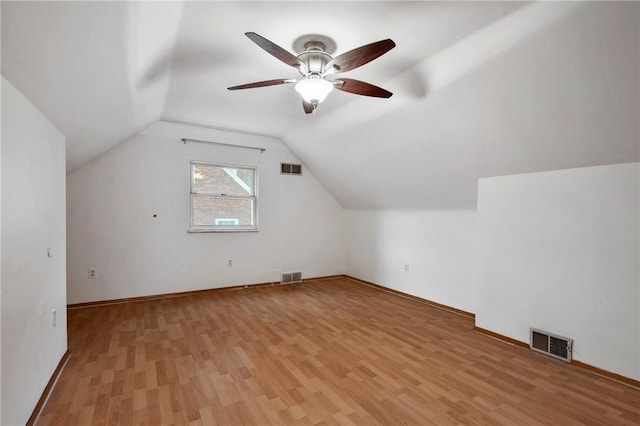 bonus room with lofted ceiling, visible vents, and light wood-style floors