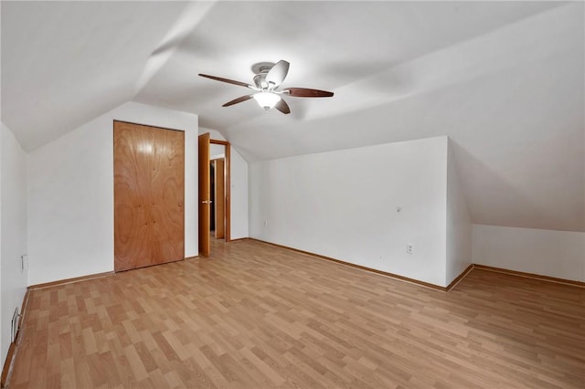 bonus room featuring light wood-type flooring, vaulted ceiling, baseboards, and ceiling fan