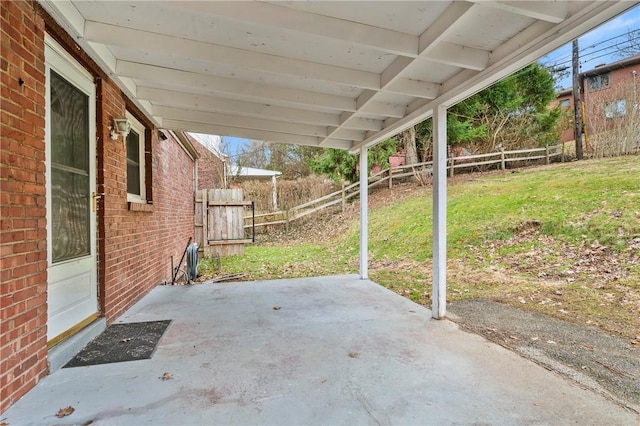 view of patio with a carport and fence