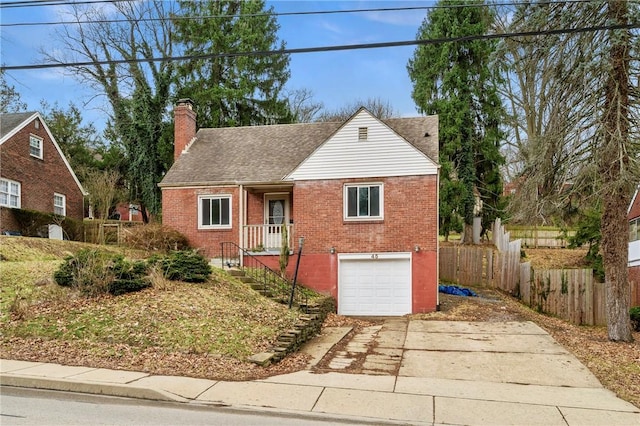 bungalow-style home with brick siding, a chimney, concrete driveway, an attached garage, and fence