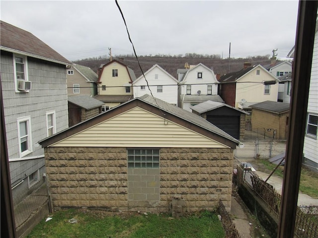 view of home's exterior featuring a residential view and fence