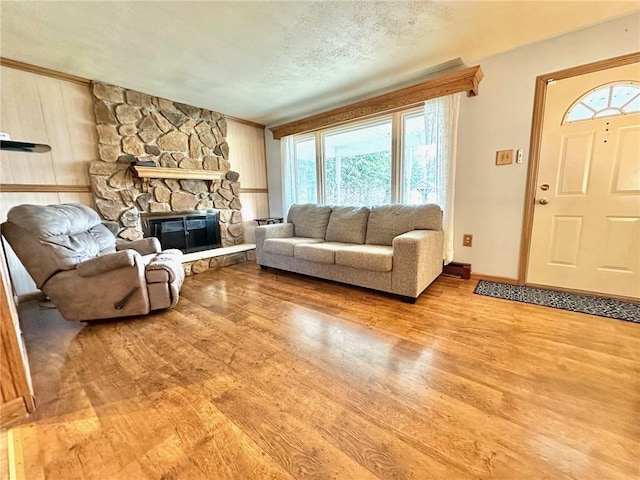 living room featuring wood finished floors, a wealth of natural light, and a fireplace