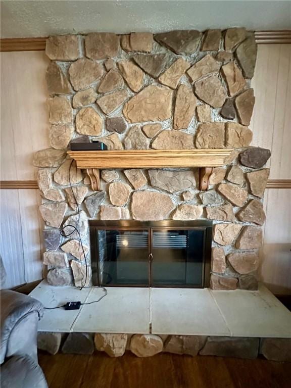 details featuring wood finished floors and a stone fireplace