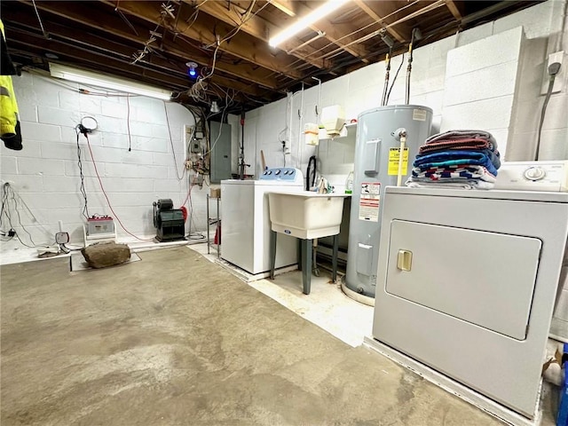 clothes washing area with water heater, separate washer and dryer, laundry area, electric panel, and a sink