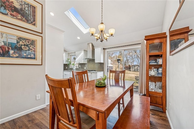 dining space featuring lofted ceiling with skylight, baseboards, and dark wood-style flooring