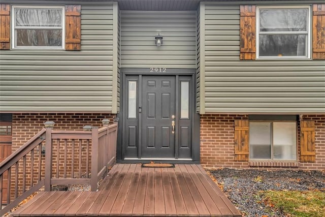 doorway to property with brick siding