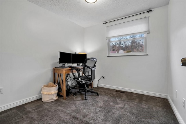 home office with dark colored carpet, a textured ceiling, and baseboards