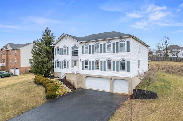 view of front of house with a front yard, driveway, and an attached garage