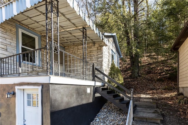 view of side of home featuring stairway