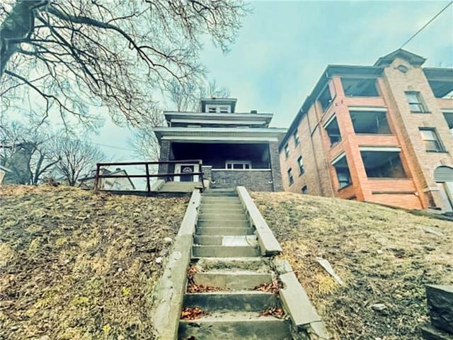 view of front facade featuring stairs