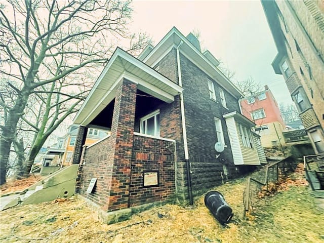 view of side of property with brick siding