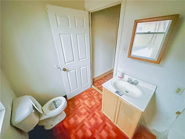 half bathroom featuring toilet and vanity