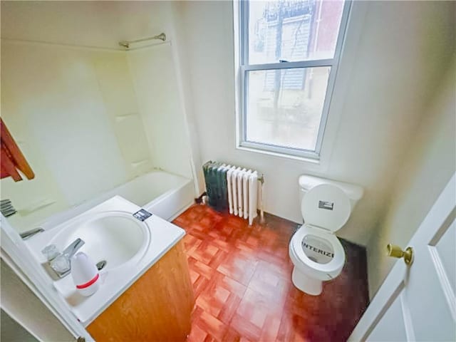 full bath featuring radiator, toilet, and vanity