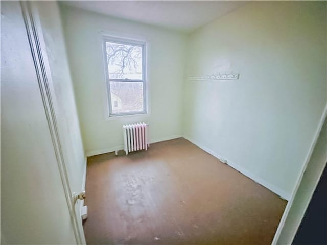 empty room featuring radiator heating unit